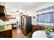 Cozy kitchen with wood cabinets, stainless steel refrigerator and dining area by the window at 126 Brunswick Dr, Greenwood, IN 46143
