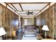 Living room with wood paneling, ceiling fan and cozy seating area at 126 Brunswick Dr, Greenwood, IN 46143