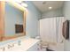 Bathroom with a single sink vanity, wood-framed mirror, and shower-tub combination at 131 Stamford Dr, Pittsboro, IN 46167