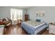Bedroom with a piano, wooden furniture, patterned bedding, and natural light from a window at 131 Stamford Dr, Pittsboro, IN 46167