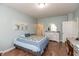 Comfortable bedroom with wooden floors, bed with patterned blanket, and white dresser at 131 Stamford Dr, Pittsboro, IN 46167