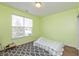 Cozy bedroom featuring a window for natural light and a patterned rug on a wood floor at 131 Stamford Dr, Pittsboro, IN 46167