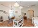 Cozy dining area with shiplap walls, pendant lighting, and a charming chandelier at 131 Stamford Dr, Pittsboro, IN 46167