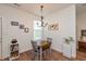 Charming dining area featuring shiplap walls, a chandelier, and a window letting in natural light at 131 Stamford Dr, Pittsboro, IN 46167