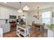 Well-lit kitchen with white cabinets, stainless steel appliances, and adjacent dining area with ample natural light at 131 Stamford Dr, Pittsboro, IN 46167