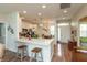 Modern kitchen with white cabinets, stainless steel appliances, breakfast bar, and wood floors at 131 Stamford Dr, Pittsboro, IN 46167