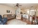 Inviting open-concept living room with wood floors, neutral decor, and seamless flow to the kitchen at 131 Stamford Dr, Pittsboro, IN 46167