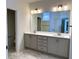 Bathroom boasts double vanity with ample storage and a large mirror with lighting at 14913 Higgins Dr, Westfield, IN 46074