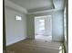 Spacious bedroom with trey ceilings, large windows, and an open doorway to another room at 14913 Higgins Dr, Westfield, IN 46074
