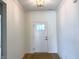Welcoming entryway features a stylish light fixture and a white front door with glass panel at 14913 Higgins Dr, Westfield, IN 46074