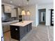 Stylish kitchen featuring a large island with marble countertop and elegant pendant lights at 14913 Higgins Dr, Westfield, IN 46074