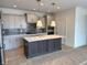 Well-appointed kitchen features an island, stainless appliances, and gray subway tile backsplash at 14913 Higgins Dr, Westfield, IN 46074