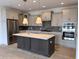 Modern kitchen boasts stainless steel appliances, large island, and stylish lighting at 14913 Higgins Dr, Westfield, IN 46074