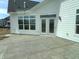 Spacious patio with white siding, large windows, and double doors to the backyard at 14913 Higgins Dr, Westfield, IN 46074