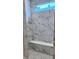 Luxurious shower featuring marble-style tile, a built-in bench, and a window at 14913 Higgins Dr, Westfield, IN 46074