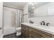 Modern bathroom featuring double sinks, bathtub, and sleek black tile floor at 1534 Fletcher Ave, Indianapolis, IN 46203