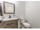A well lit half bathroom featuring a floating vanity and minimalist style at 1534 Fletcher Ave, Indianapolis, IN 46203
