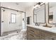 Bright bathroom featuring a glass enclosed shower and double vanity with stylish tile flooring at 1534 Fletcher Ave, Indianapolis, IN 46203