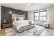 A bedroom featuring lots of natural light, textured accent wall, and a soft color palette at 1534 Fletcher Ave, Indianapolis, IN 46203