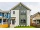 Charming two-story home with white siding, green trim, and well-manicured lawn at 1534 Fletcher Ave, Indianapolis, IN 46203