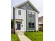 Charming two-story home with white siding, green trim, and well-manicured lawn at 1534 Fletcher Ave, Indianapolis, IN 46203