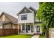 Charming two-story home featuring a covered porch with seating and a well-manicured front lawn at 1534 Fletcher Ave, Indianapolis, IN 46203