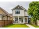 Charming two-story home featuring a covered porch with seating and a well-manicured front lawn at 1534 Fletcher Ave, Indianapolis, IN 46203