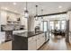 A kitchen with white cabinets, a large island, decorative backsplash, and stainless steel appliances at 1534 Fletcher Ave, Indianapolis, IN 46203