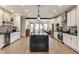 Bright kitchen with an island, stainless steel appliances, white cabinetry, and modern backsplash at 1534 Fletcher Ave, Indianapolis, IN 46203
