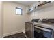 Functional laundry room with modern washer, dryer, and upper storage shelf at 1534 Fletcher Ave, Indianapolis, IN 46203