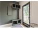 A mudroom featuring bench seating, shelving, and a view to the exterior at 1534 Fletcher Ave, Indianapolis, IN 46203
