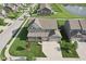 Aerial view of the property showcasing the well-manicured lawn, landscaping, and community pond at 16112 Lavina Ln, Fishers, IN 46040