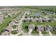 Aerial view of a residential neighborhood with tree-lined streets, a pond, and community amenities at 16112 Lavina Ln, Fishers, IN 46040