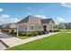 Exterior of a community building with beige siding, green lawn, and bike racks at 16112 Lavina Ln, Fishers, IN 46040