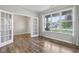 Bright, empty room with wood floors, large windows, and a glass door leading to another space at 16112 Lavina Ln, Fishers, IN 46040
