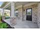 Welcoming front porch with brick accents and a black front door and sidelight at 16112 Lavina Ln, Fishers, IN 46040