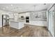 Bright, open kitchen featuring stainless steel appliances, an island, and wood floors at 16112 Lavina Ln, Fishers, IN 46040