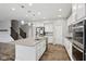 Modern kitchen with a center island, stainless steel appliances, and hardwood flooring at 16112 Lavina Ln, Fishers, IN 46040