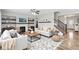 Stylishly staged living room featuring a fireplace, modern furniture, and hardwood floors at 16112 Lavina Ln, Fishers, IN 46040