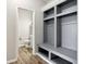 Mudroom featuring built-in storage and wood flooring at 16112 Lavina Ln, Fishers, IN 46040