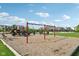 Community playground with swings and slide set among a lawn and mulch at 16112 Lavina Ln, Fishers, IN 46040