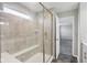 Tiled shower with glass enclosure, a built-in seat and a small window at 16112 Lavina Ln, Fishers, IN 46040