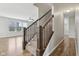 Carpeted staircase with wooden handrail leading to the upper level and living room at 16112 Lavina Ln, Fishers, IN 46040