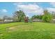 Expansive backyard featuring lush green grass, mature trees, a playset and a fenced perimeter at 1633 E Thompson Rd, Indianapolis, IN 46227