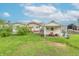Large backyard with green grass, a playset, and a covered patio area, perfect for outdoor activities at 1633 E Thompson Rd, Indianapolis, IN 46227