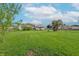 Sprawling backyard with lush green grass, a playset, and a secure wooden fence at 1633 E Thompson Rd, Indianapolis, IN 46227