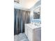 Well-lit bathroom featuring a large mirror, vanity and shower with gray, polka dot shower curtain at 1633 E Thompson Rd, Indianapolis, IN 46227