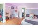 Roomy bedroom with hardwood floors, desk, and decorative ambient lighting at 1633 E Thompson Rd, Indianapolis, IN 46227