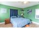 Relaxing bedroom with cool toned walls, carpet floors, and plenty of natural light at 1633 E Thompson Rd, Indianapolis, IN 46227
