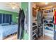 A shared room with a bedroom and walk-in closet, featuring wooden floors and ample storage at 1633 E Thompson Rd, Indianapolis, IN 46227